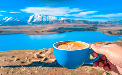 A cup of coffee on the background of snowy mountains