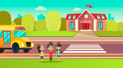 Fototapeta premium Pupils are near the school bus. School across the road. Transition in front of the school. Students are going to learn.