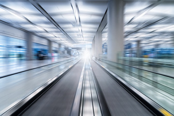 escalator motion blur in airport terminal
