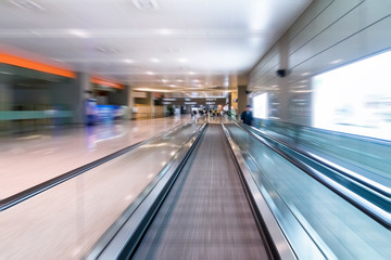 escalators in airport walkway
