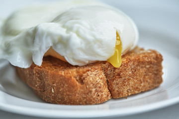 The egg poached is on toast. Closeup