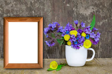 Bouquet of primroses blue lungwort in white enameled metal mug on table and vintage background, grunge with white paper sheet for text, vintage, copy space, mock up
