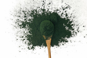 Algae spirulina.Spirulina powder in wooden spoon  on white background.Super food . seaweed.