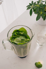 Making green smoothie. Natural, organic healthy juice in bottle for weight loss diet