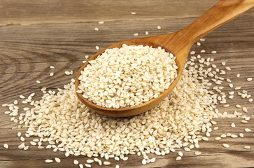 White sesame on wooden background