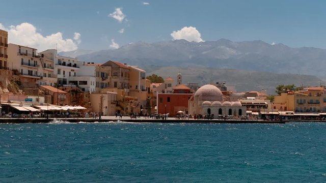 Tracking shot of the Old Town promenade in Chania, Crete, Greece featuring the famous Mosque of the Janissaries