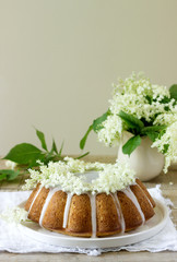 Lemon pie with a glaze of sugar and elderflower syrup, decorated with elderberry flowers. Rustic...