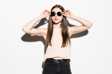 Young teenage woman wearing sunglasses isolated on white