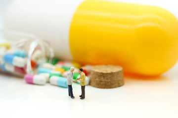 Miniature people : Businessman with Capsule pill,Drug resistance business concept