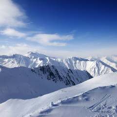 Fototapeta na wymiar Snowy mountains and blue sky