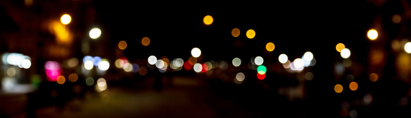 Bokeh traffic light at night in the street of a big city