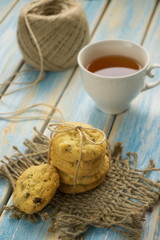 cup of tea with biscuits on a blue wooden background