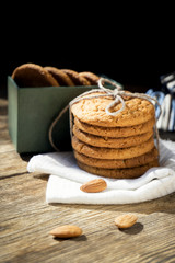 a stack of cookies next to a cookie in a box