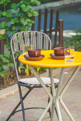 Table in a street cafe with coffee cups