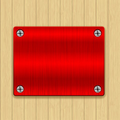 Wooden background with red metal plate