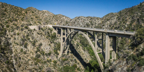 Long narrow bridge across mountain valley in the national forest of southern California.
