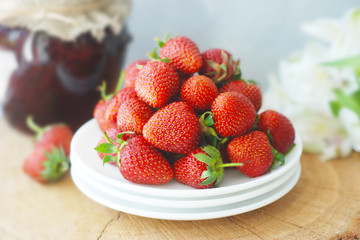 Strawberry Jam and Fresh Strawberries Textured Cement Gray Background and Jam Jar