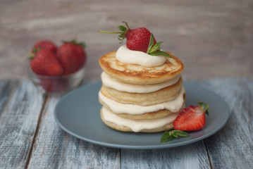 Sweet Pancakes with Cream and Strawbery. Health Breakfast Fruit Berry Vitamine Gray Rustic Wooden Background