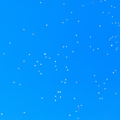 White balls flying in the blue sky