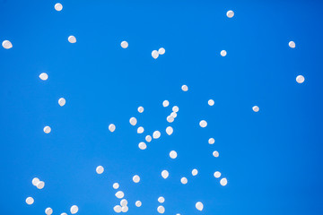 White balls flying in the blue sky