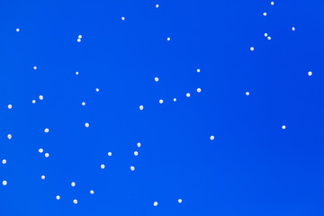 White balls flying in the blue sky