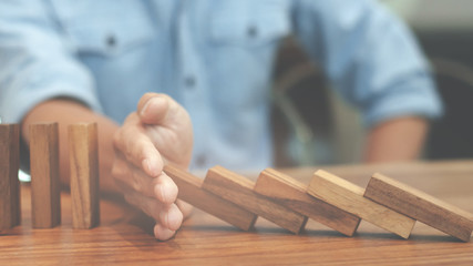 Risk and strategy wealth plan - man hand with wooden block thinking about value investment