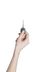 Female hand holding a car key on isolated background