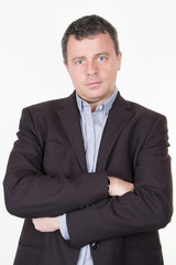 Portrait of serious businessman arms crossed isolated on white