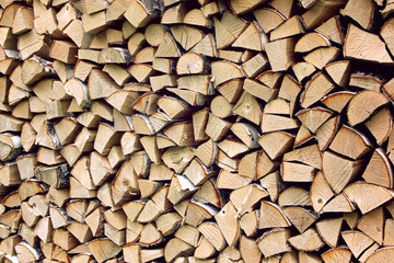 Stack of firewood, wooden abstract background.