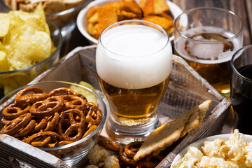 glass of beer and an assortment of snacks