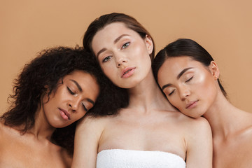 Beauty portrait of three nude multiracial women: caucasian, african american and asian girls,...
