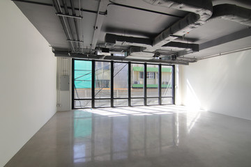 Empty office room on modern building with sunlight and indoor ventilation system on hight ceiling of large building