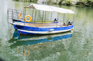 Fototapeta na wymiar Small boat and reflection on water.
