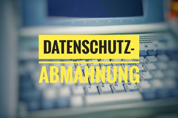 Laptop with in german Datenschutz-Abmahnung in english privacy warning