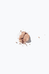 Broken face powder on white background