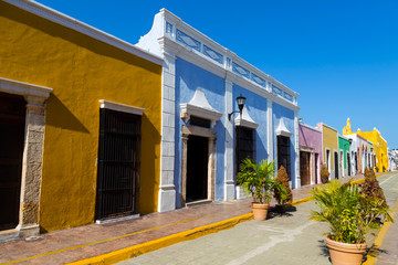 Colorful empty colonial street in the historic center of Campeche. Facade of a house with a colored wall
