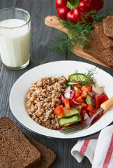 Buckwheat porridge and vegetable salad in a bowl    
