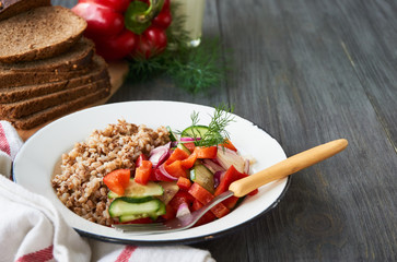 Buckwheat porridge and vegetable salad in a bowl    