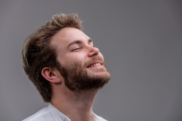 Blissful young man with his head tilted back