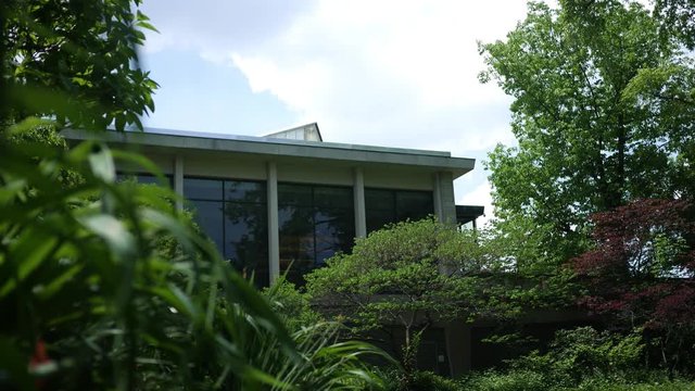 The second story of a contemporary building as seen from a park