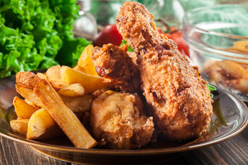 Crispy fried kentucky chicken legs with french fries