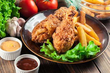 Crispy fried kentucky chicken legs with french fries