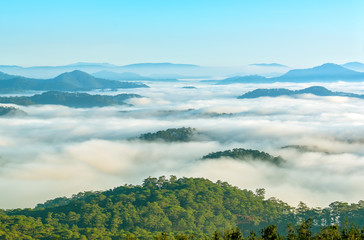 Landscape under morning fog covered the valley like clouds floating in wonderful idyllic highlands of Dalat, Vietnam