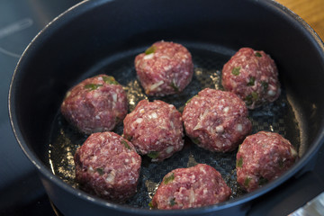 Making meatballs in a kitchen 