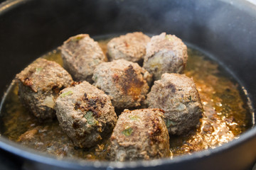 Making meatballs in a kitchen 
