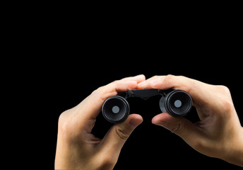 Binocular on hand holding isolated on black background with clipping path