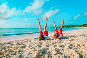 father and little son play on beach