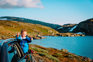 happy child enjoy travel by car in mountains
