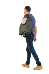 Naklejka premium back view of walking man with green bag.