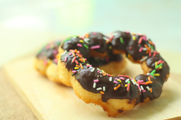 Donuts with icing on wood.Chocolate donuts.